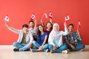 Students from different nationalities holding Canada flag in their hand