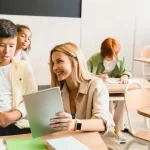 A young teacher/tutor helping her students with school work