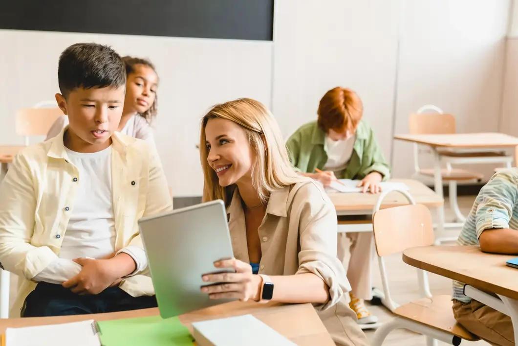 A young teacher/tutor helping her students with school work