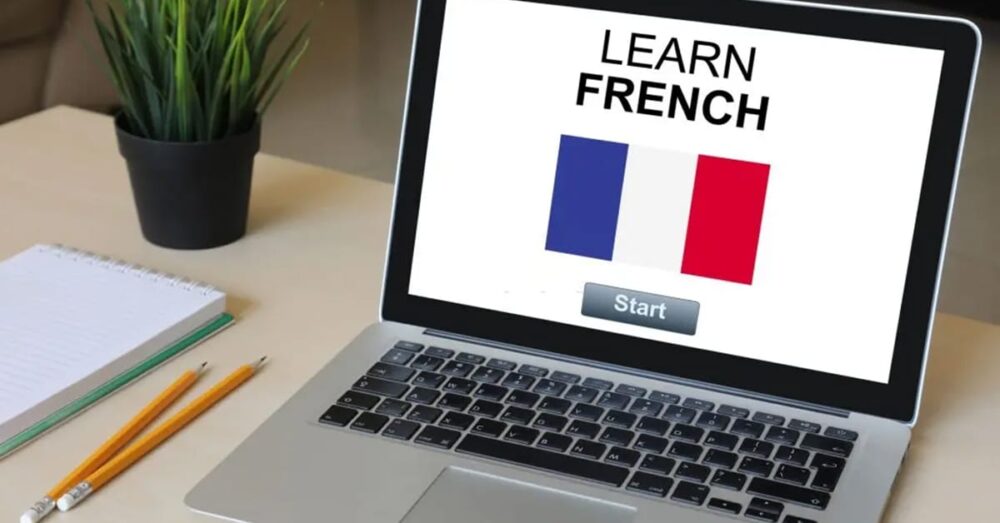 Laptop showing France national flag with learn French class start button