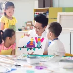 Children in an art class with teacher