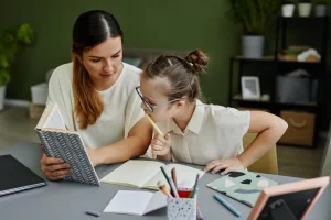 A mother helping her daughter with Down syndrome study