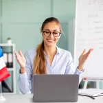 Young teacher giving online French lesson