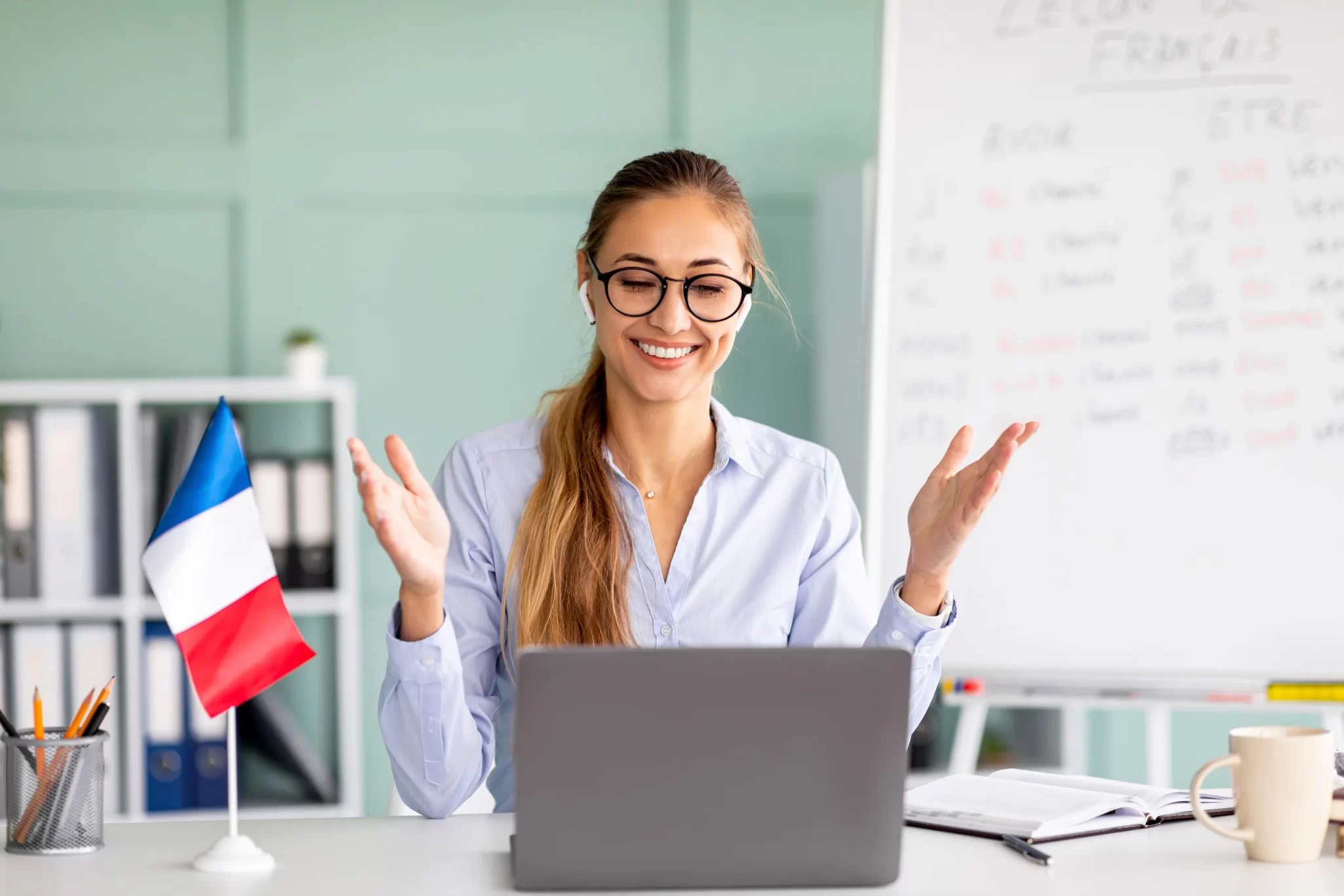 Young teacher giving online French lesson